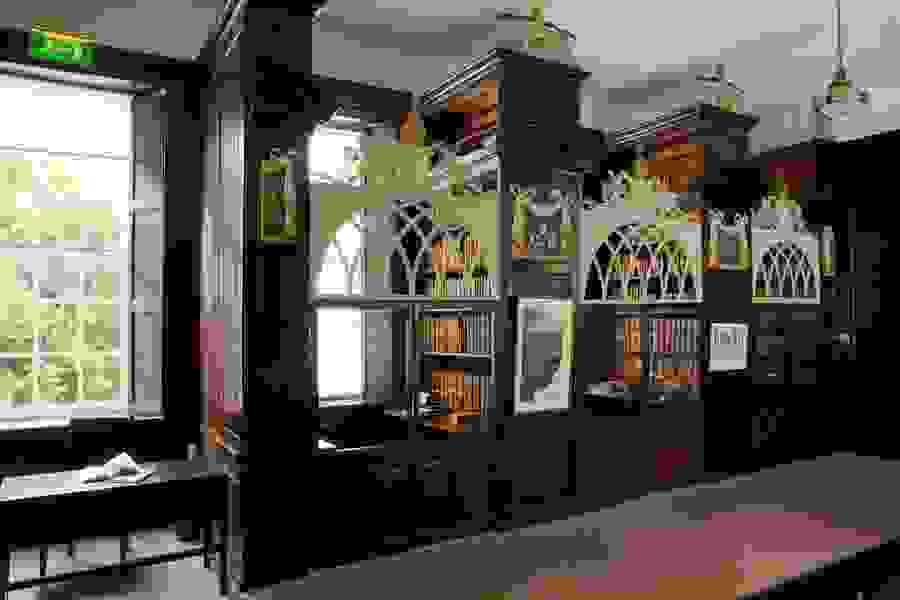 Ornate wooden reading cages with arched lattice doors and old books in Marsh's Library, Dublin.