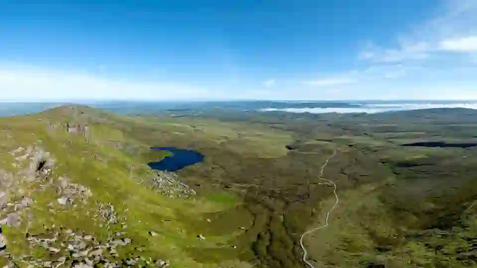 Cuilcagh Boardwalk Trail in County Fermanagh, Ireland, with mountain views and a winding wooden path.