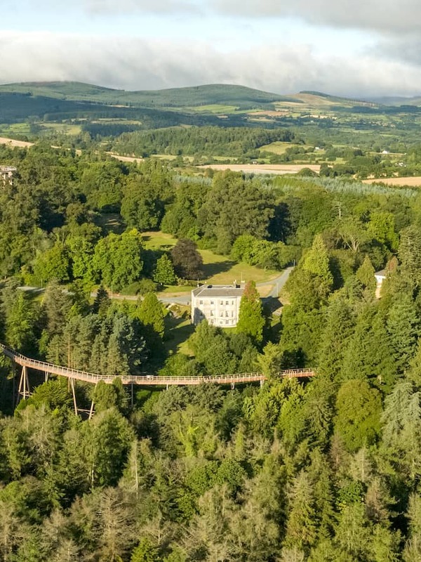 Aerial view of Beyond the Trees treetop walkway at Avondale, County Wicklow, surrounded by lush woodland and hills.