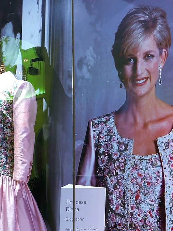 Fashion exhibit at the Museum of Style Icons, County Kildare, featuring a pink gown in a glass display beside a large portrait of Princess Diana.