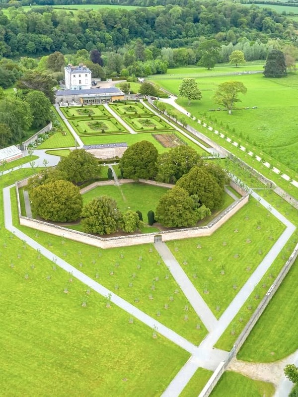 Aerial view of Oldbridge House and the Battle of the Boyne visitor centre with formal walled gardens, surrounded by lush green parkland in County Meath.