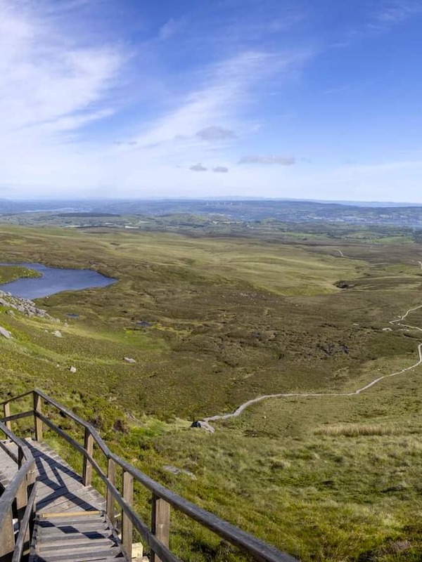 Wooden boardwalk trail winding through the Cuilcagh Mountain uplands with panoramic views across County Fermanagh.