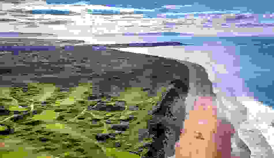 Aerial view of Royal Portrush Golf Club and Whiterocks Beach along the Causeway Coast in County Antrim, Northern Ireland.