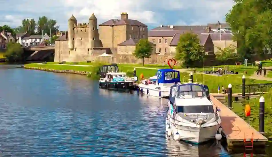 Boats moored along the River Erne beside the medieval Enniskillen Castle in County Fermanagh.