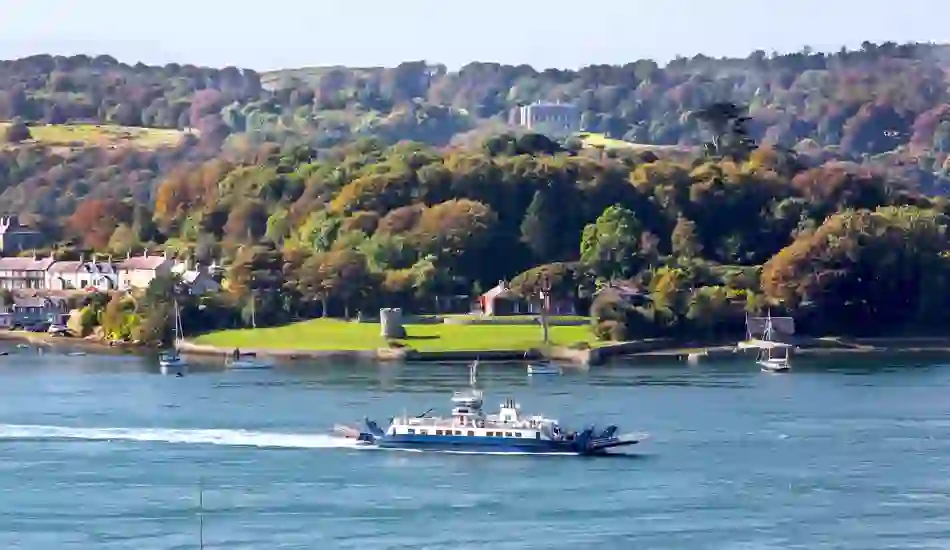 Traditional fishing boats in Portaferry Harbour with Strangford Lough and Mourne Mountains in the background.