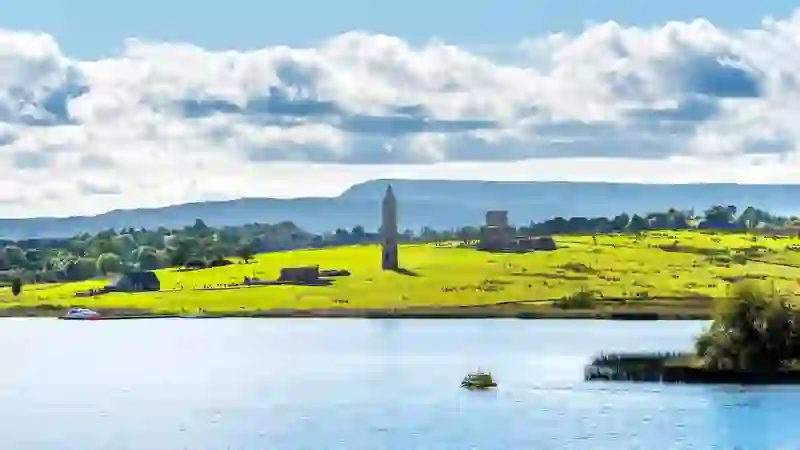 Round tower and monastic ruins on Devenish Island in Lough Erne, County Fermanagh, on a bright summer day.