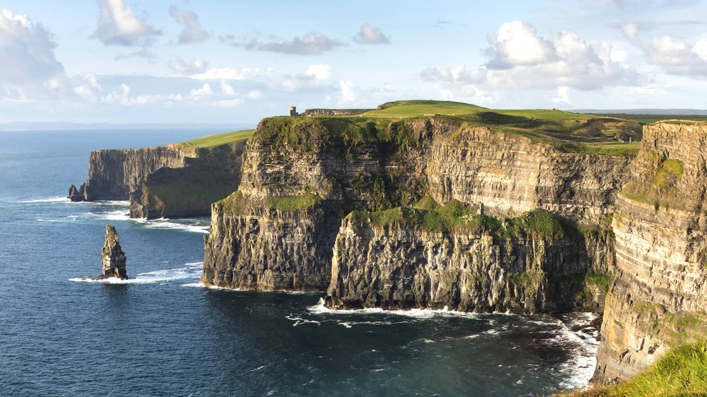 Sheer sea cliffs and crashing Atlantic waves at the iconic Cliffs of Moher in County Clare, Ireland.