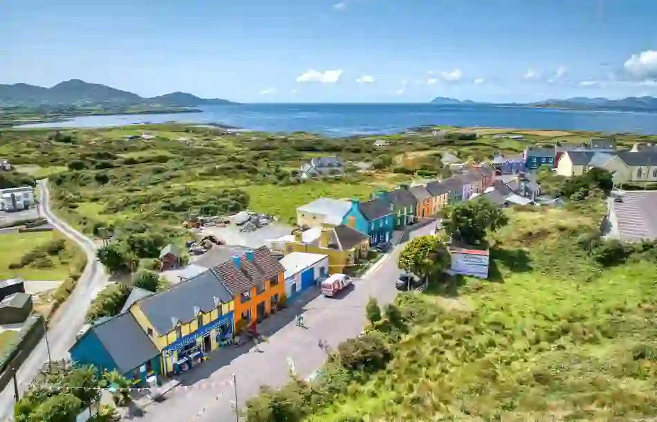 Aerial view of rainbow-painted houses lining a village street in Eyeries, on Cork's Beara Peninsula coast.