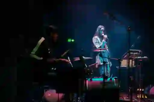 Singer and drummer performing on stage at the Dublin Fringe Festival.