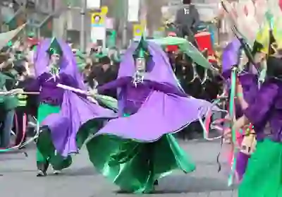 Dancers in purple and green costumes performing at the St Patrick’s Day parade.