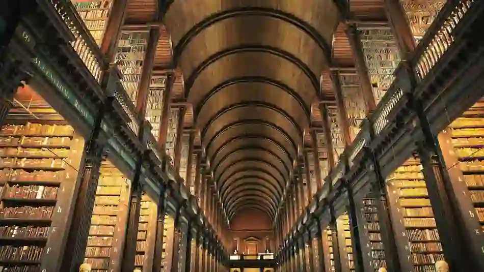 The Long Room in Trinity College Dublin, a historic library with arched ceiling and book-lined shelves.