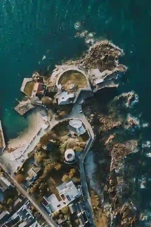 Aerial view of Forty Foot swimming spot and Sandycove coastline in Dublin showing rocky shore and clear sea.