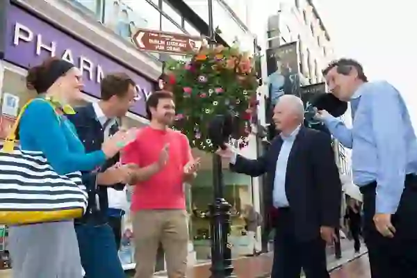 Street performers entertaining a group during the Dublin Literary Pub Crawl.