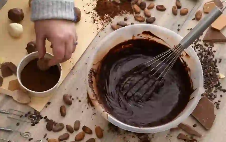Chocolate truffle making with cocoa powder, melted chocolate and cocoa beans at The Chocolate Manor.