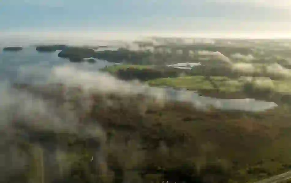 Morning mist rising over islands and woodlands of Lough Key Forest Park in County Roscommon.