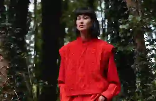 Red-on-red styling in the forest: a modern spin on Irish textiles from The Tweed Project’s striking collection.