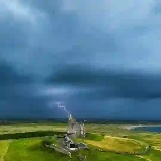 Lightning bolt striking near Classiebawn Castle under stormy skies on the Atlantic coast in County Sligo.