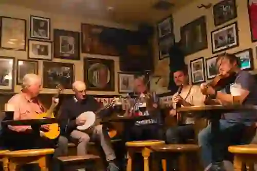 Traditional Irish musicians playing fiddles and banjo at Matt Molloy’s Pub in Westport, County Mayo.