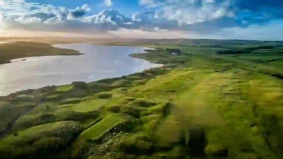 Aerial view of Castlerock Golf Course, County Londonderry, overlooking lush fairways and a winding river.
