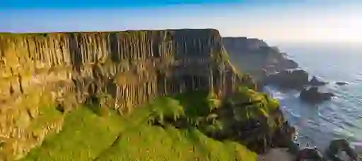View of dramatic vertical cliffs above the Atlantic Ocean along the Giant’s Causeway Coast Walk in Antrim.