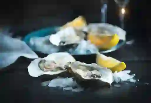 Irish oysters on ice with lemon wedges ready to be served.