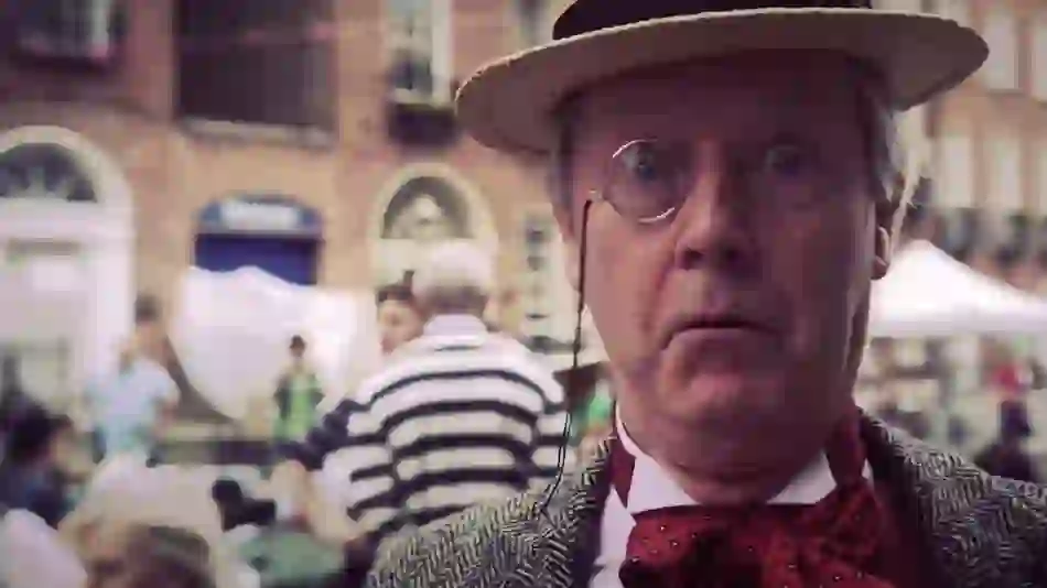 Performer in Edwardian costume with monocle at Bloomsday Festival in Dublin, referencing James Joyce’s Ulysses.