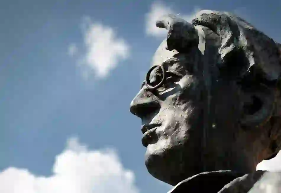 Close-up of bronze WB Yeats statue in Sligo, showing poet’s distinctive profile against a blue sky with scattered clouds.
