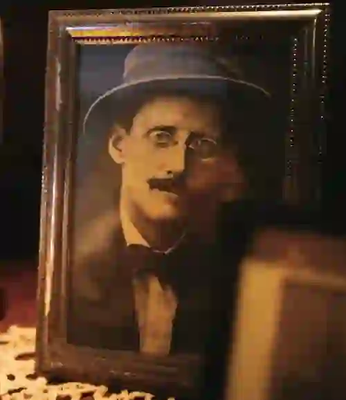 Sepia-toned framed photograph of James Joyce in a hat and bowtie, on display at the James Joyce Centre in Dublin.