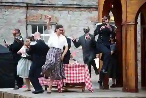 Actors in masks performing an outdoor play during Kilkenny Arts Festival.