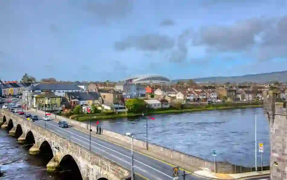 Aerial view of Limerick city with Thomond Park stadium visible beyond the rooftops.