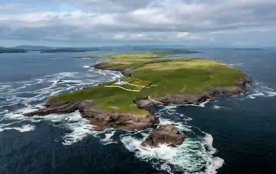 Aerial view of St John’s Point peninsula with dramatic Atlantic cliffs and rolling pastures in Donegal.