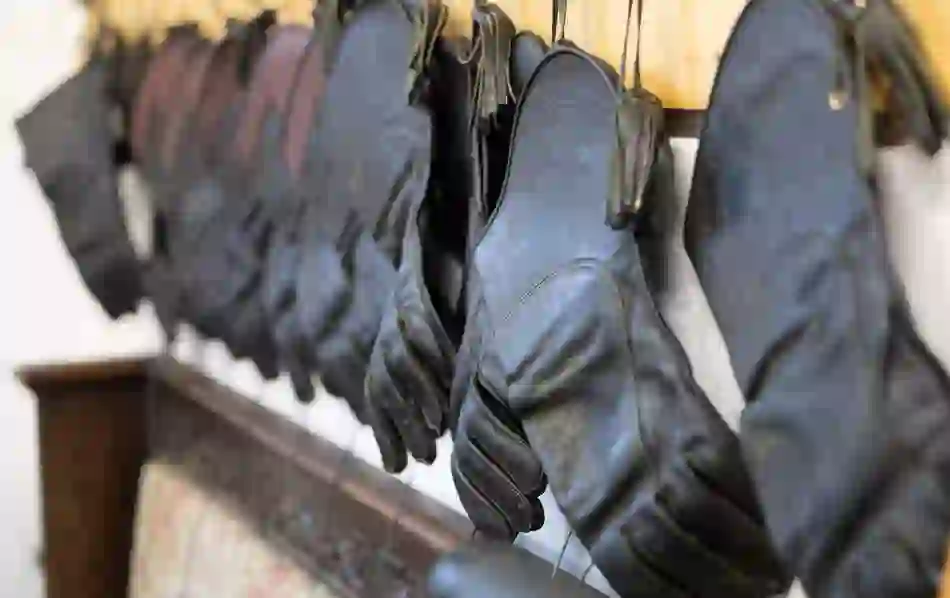 A row of black leather falconry gloves hanging in a training room at Ashford Castle, County Mayo.