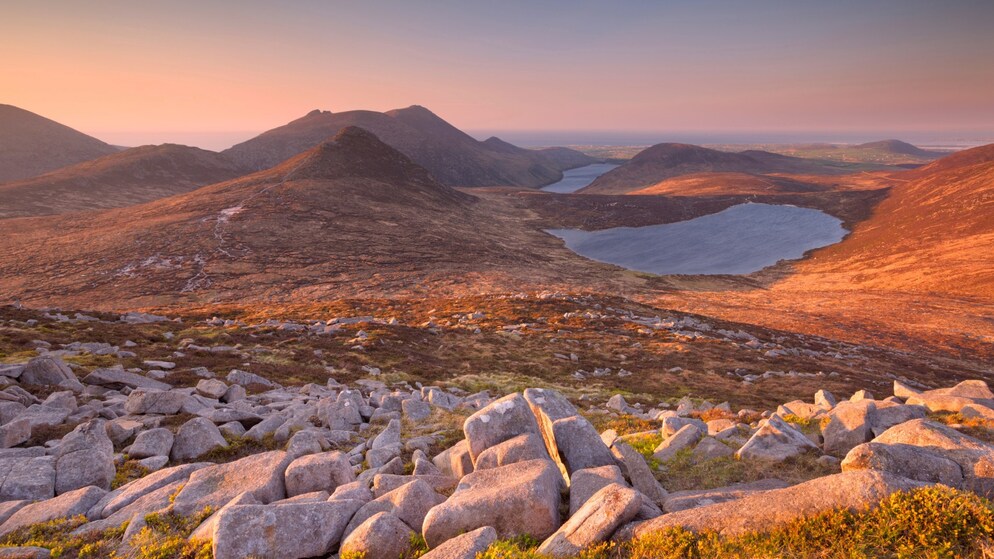 Soft sunset light over the Mourne Mountains and Silent Valley Reservoir in County Down.