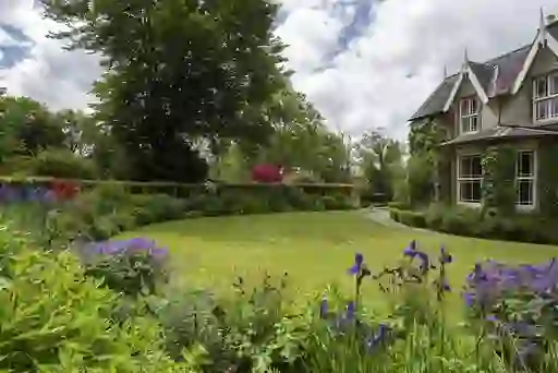 Colourful flowers and trimmed lawns surround The Old Rectory at Blackstairs Eco Trails, County Carlow.
