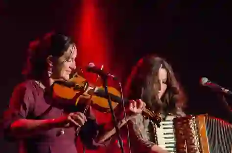 Musicians playing fiddle and accordion during a live traditional music session in Belfast's Cathedral Quarter.