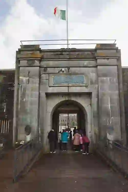 Stone archway entrance to Fort Mitchel on Spike Island with visitors entering.
