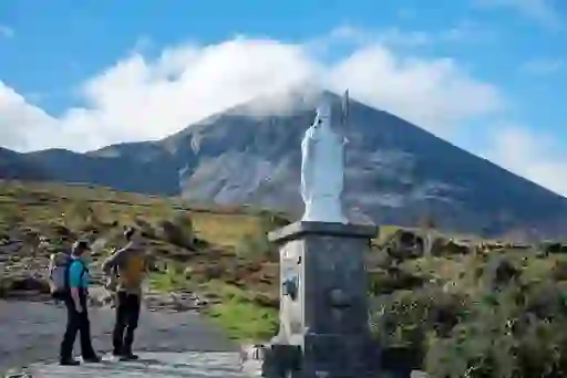 Statue of Saint Patrick with Croagh Patrick mountain in the background.