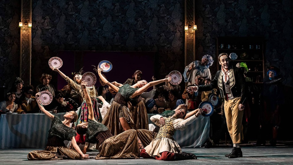 Actors perform a lively stage scene with costumes and props at an Irish theatre.