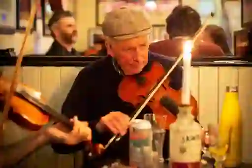 Traditional music session with a fiddle player in the Sunflower Public House, Belfast city.