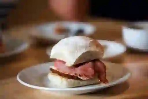 Close-up of a soft floury Waterford blaa filled with slices of grilled Irish bacon.