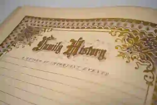Close-up of a vintage “Family History” record book with ornate gold detailing on the cover.