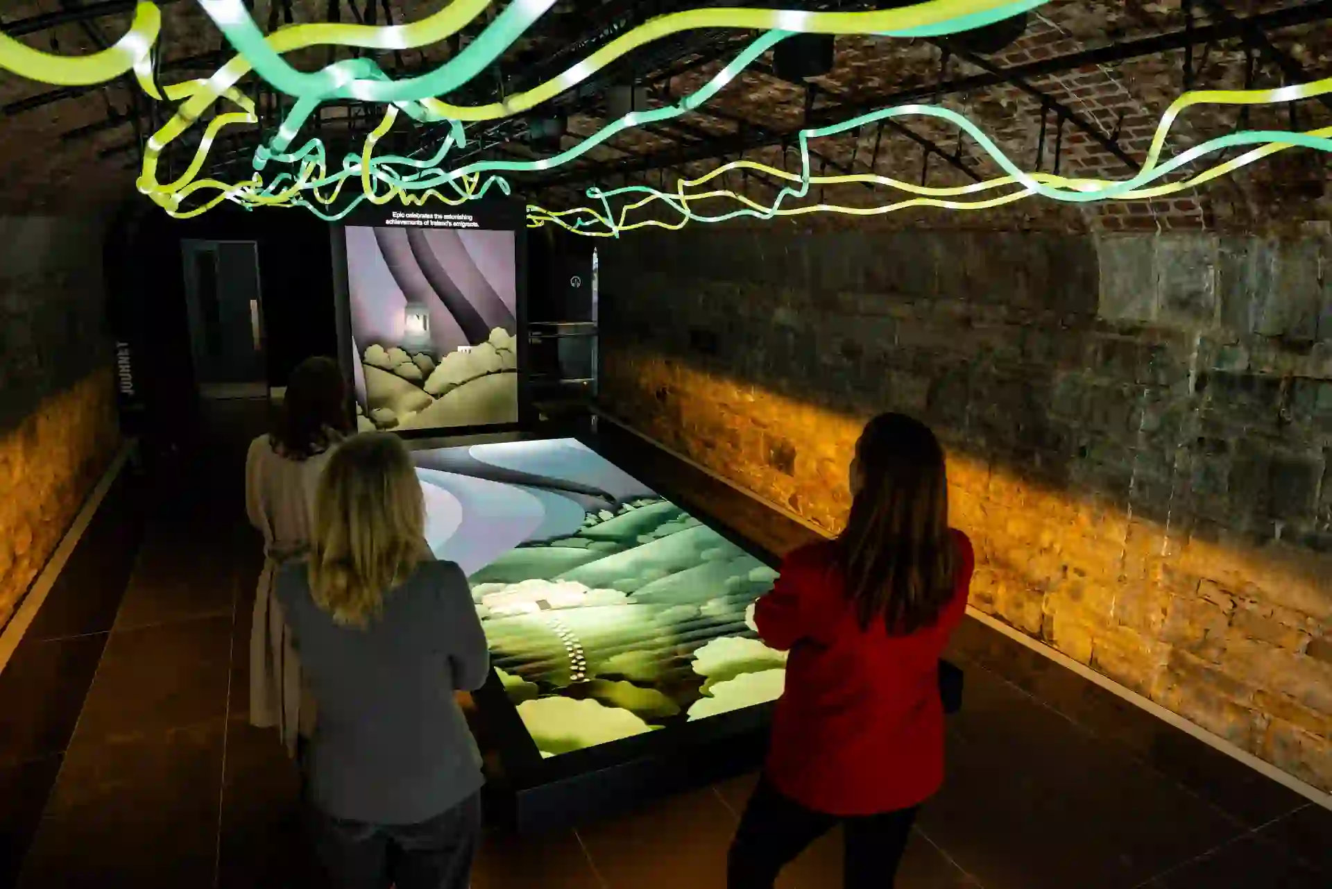 Visitors exploring an interactive family history display at the EPIC museum in Dublin.