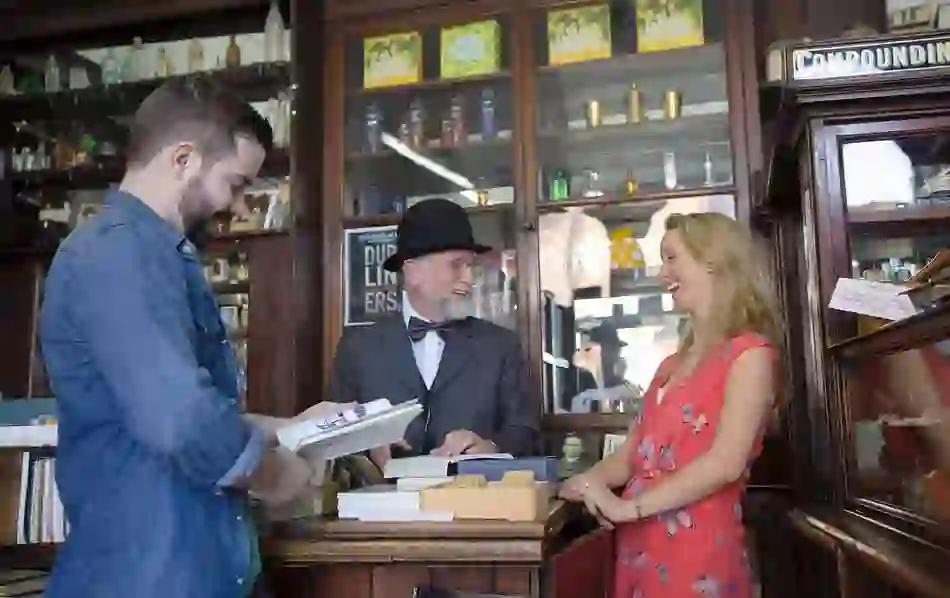 Visitors chat with a costumed guide at Sweny’s Pharmacy, a historic Dublin shop linked to James Joyce’s Ulysses.