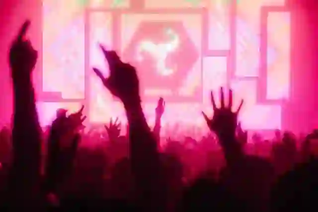 Crowd enjoying a live electronic music performance with colourful stage visuals at the AVA Festival in Belfast.