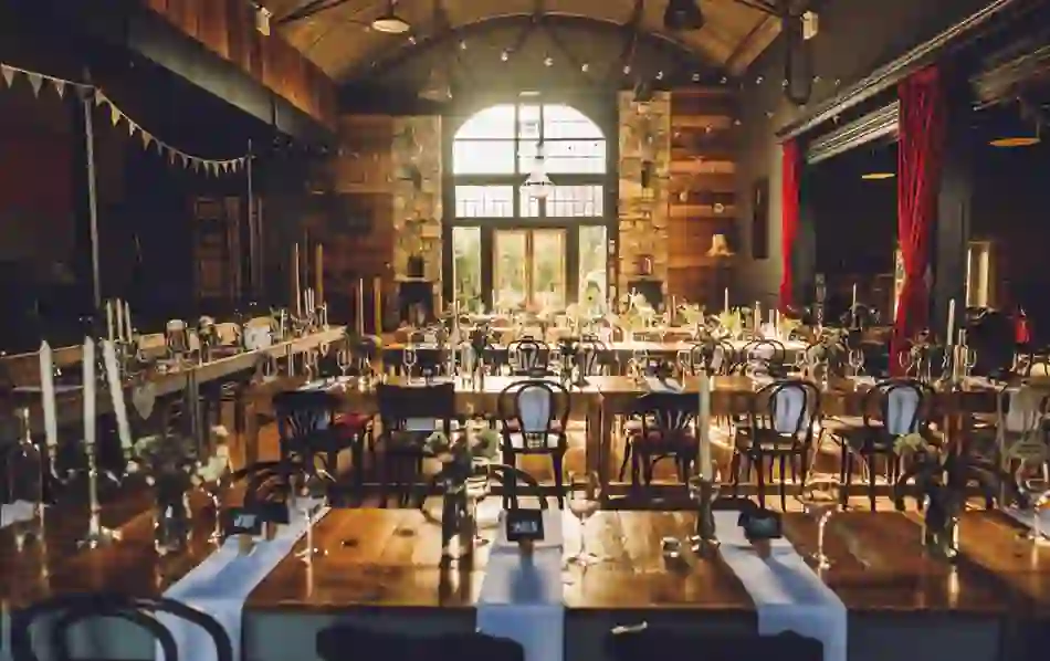 Rustic Tin Chapel at Mount Druid, Westmeath, set for a wedding with long tables, vintage chairs and warm decor.