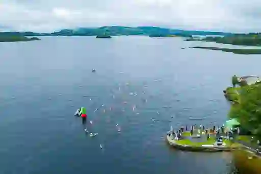 Aerial view of swimmers in brightly coloured caps taking part in the Gaelforce Great Lake Swim on Lough Derg, County Clare.