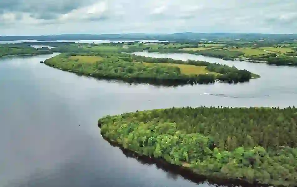 Drone view over Lough Erne with lush green White Island and surrounding lake landscape in Fermanagh.