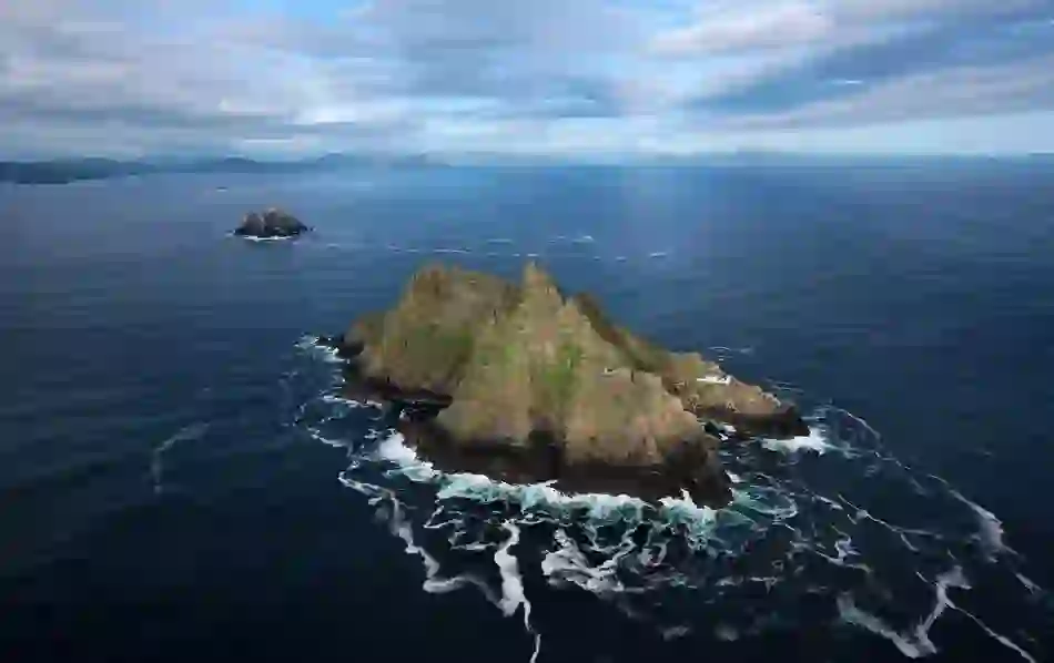 Aerial view of Skellig Michael’s jagged rock formation in County Kerry surrounded by deep blue Atlantic swells.