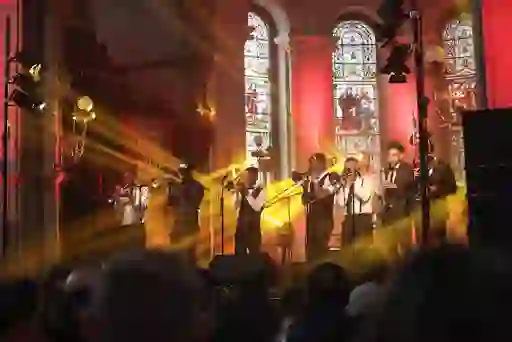 Brass band performing under stained glass windows at the Guinness Cork Jazz Festival.