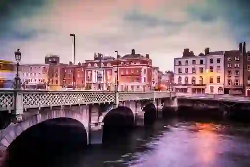 View of Grattan Bridge over the River Liffey with Georgian buildings at dusk in Dublin.